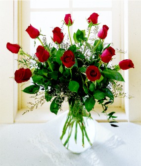 A Dozen Long Stem Roses with Filler and Greens in a Vase 
