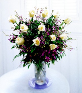 A Dozen Long Stem Roses with Filler in a Beautiful Vase