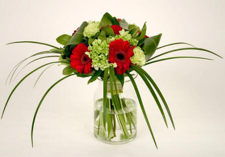 Tropical Ti leaves embrace this sophisticated hand-tied bouquet 