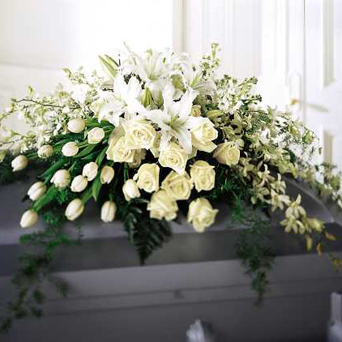 Resplendent monochromatic casket cover. Roses, Tulips, Orchids, and Lilies are grouped together by flower type in an elegant and sophisticated display.  Approximate Dimensions : 14”h x 30”w.  (½ casket cover as shown) $360.00  Full casket cover $700.00  FTD S19-3153